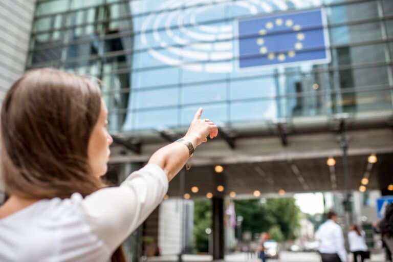 woman points to european union flag